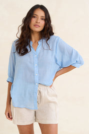 Model Tahnee wearing size 10 of the Cotton Button Down Blouse in colour Blue (Blue), from the front, showing the whole outfit