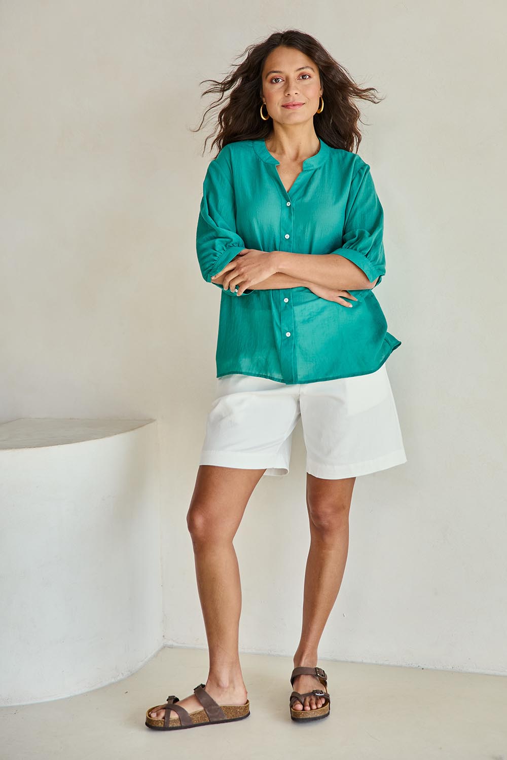 Model Tahneei wearing size 10 of the Cotton Button Down Blouse – Lagoon in colour Lagoon, from the front
