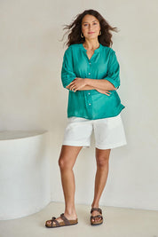 Model Tahneei wearing size 10 of the Cotton Button Down Blouse – Lagoon in colour Lagoon, from the front