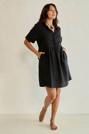 Model Tahnee wearing size 10 of the Linen Throw On Dress in colour Black (Black), from the front, showing the whole outfit