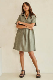 Model Tahnee wearing size 10 of the Linen Throw On Dress in colour Olive (Green), from the front, showing the whole outfit