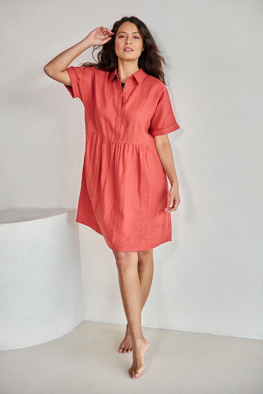 Model Tahneei wearing size 10 of the Linen Throw On Dress – Rust in colour Rust, from the front