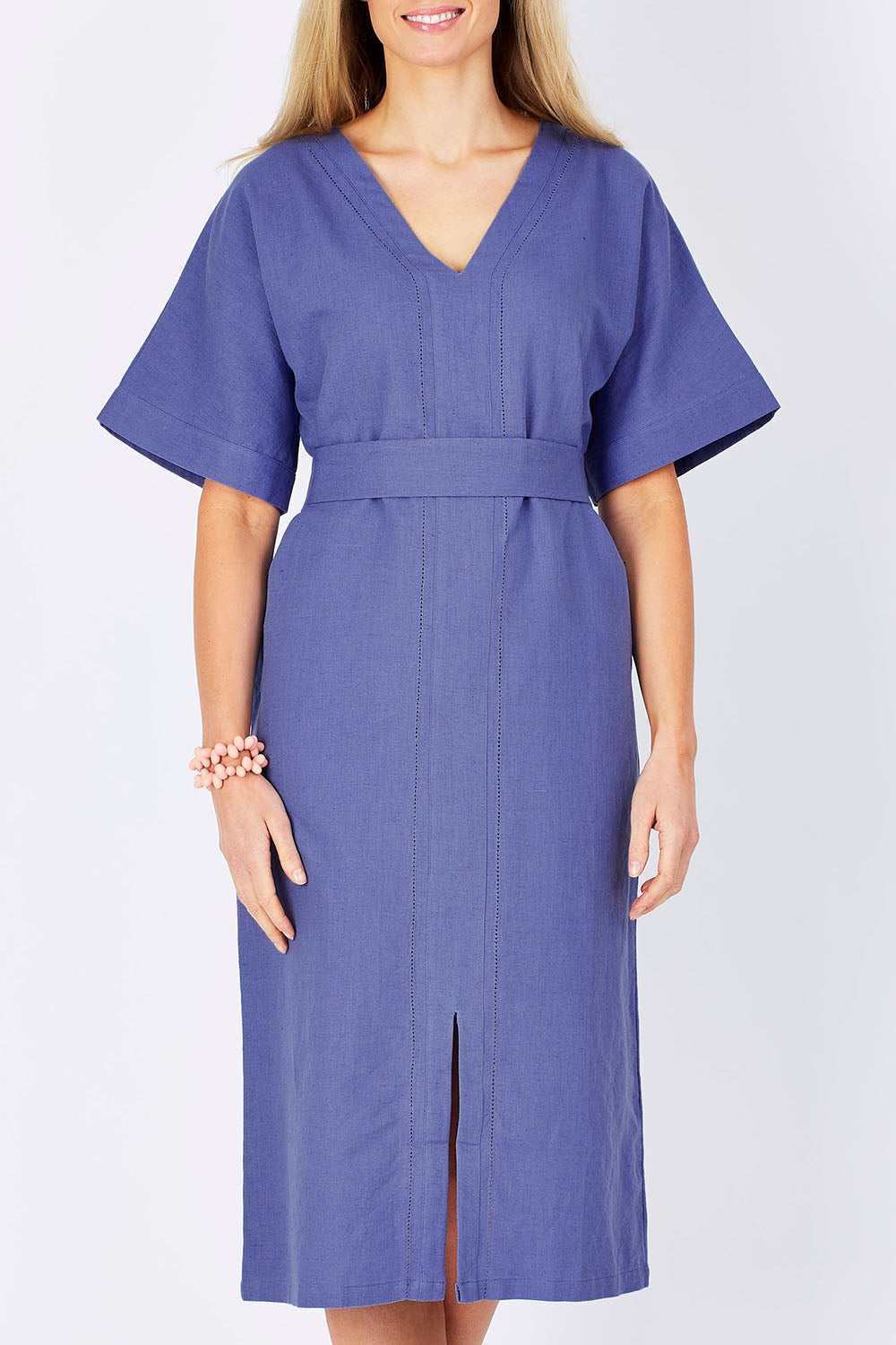 Model Maddy wearing size 10 of the Natural Throw Dress in colour Fleet (Blue), from the front, cropped image