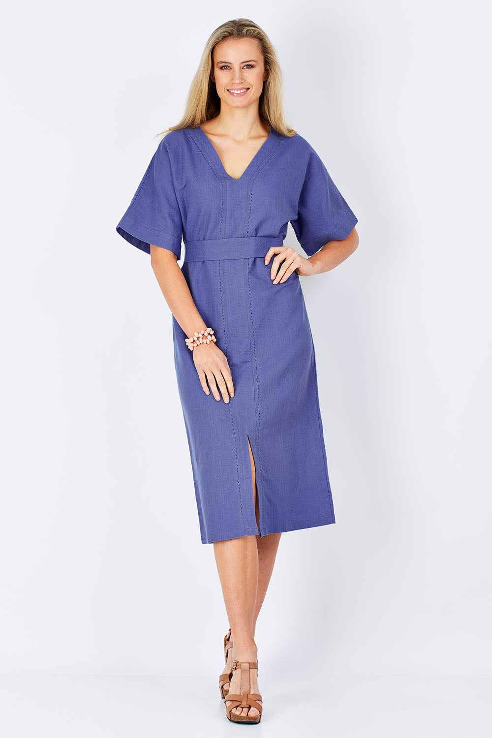 Model Maddy wearing size 10 of the Natural Throw Dress in colour Fleet (Blue), from the front, showing the whole outfit