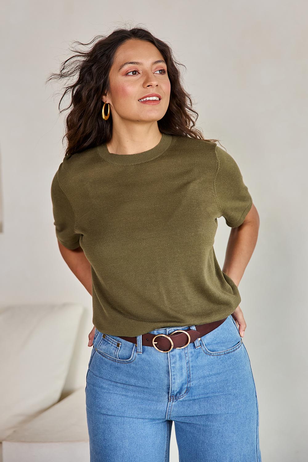 Model Tahneei wearing size 10 of the Linen Lyocell Textured Knit Tee – Green in colour Green, from an angle