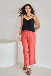 Model Tahneei wearing size 10 of the Linen Cropped Drawstring Pant – Rust in colour Rust, from the front