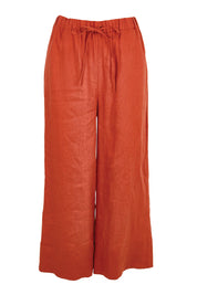 Product shot of the Linen Cropped Drawstring Pant – Rust in colour Rust, from the front