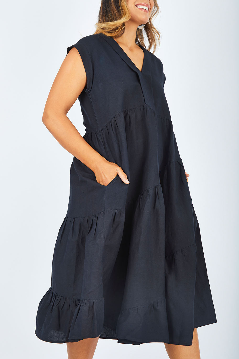 Model Palatina wearing size 14 of the Cotton Linen Tier Dress in colour Midnight (Black), from the front, cropped image