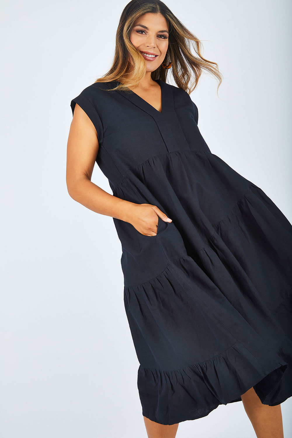 Model Palatina wearing size 14 of the Cotton Linen Tier Dress in colour Midnight (Black), from the front, cropped image