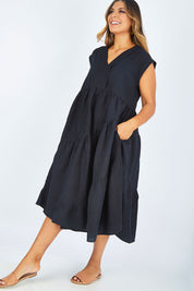 Model Palatina wearing size 14 of the Cotton Linen Tier Dress in colour Midnight (Black), from the front, showing the whole outfit