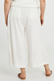 Model Keeara wearing size 16 of the Linen Drawstring Pants in colour White (White), from the back