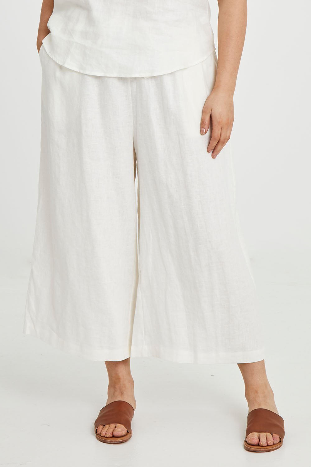 Model Keeara wearing size 16 of the Linen Drawstring Pants in colour White (White), from the front, cropped image