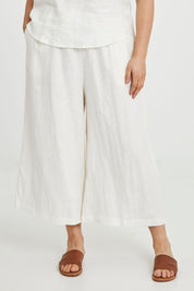 Model Keeara wearing size 16 of the Linen Drawstring Pants in colour White (White), from the front, cropped image