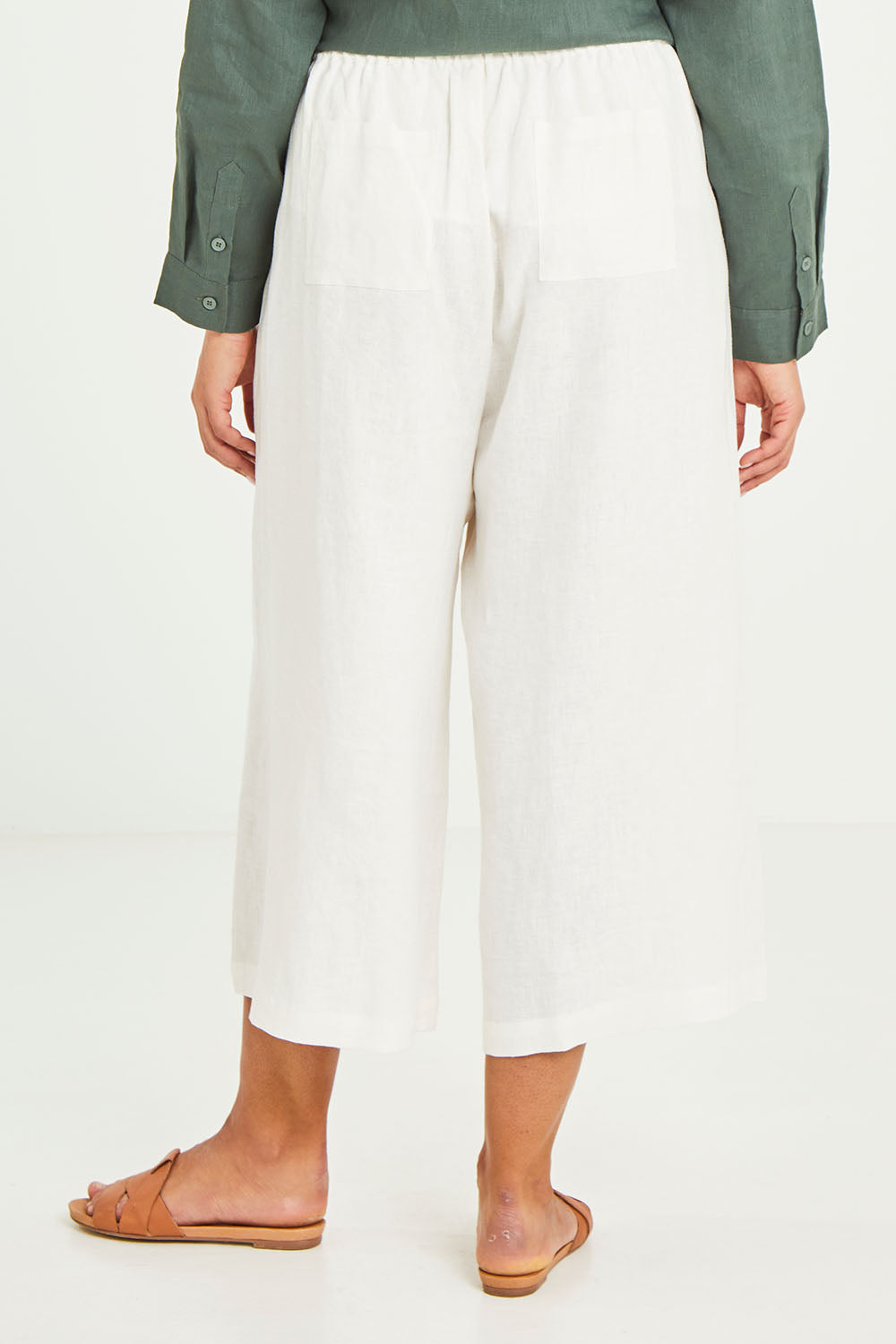 Model Terri-Leigh wearing size 14 of the Linen Drawstring Pants in colour White (White), from the back
