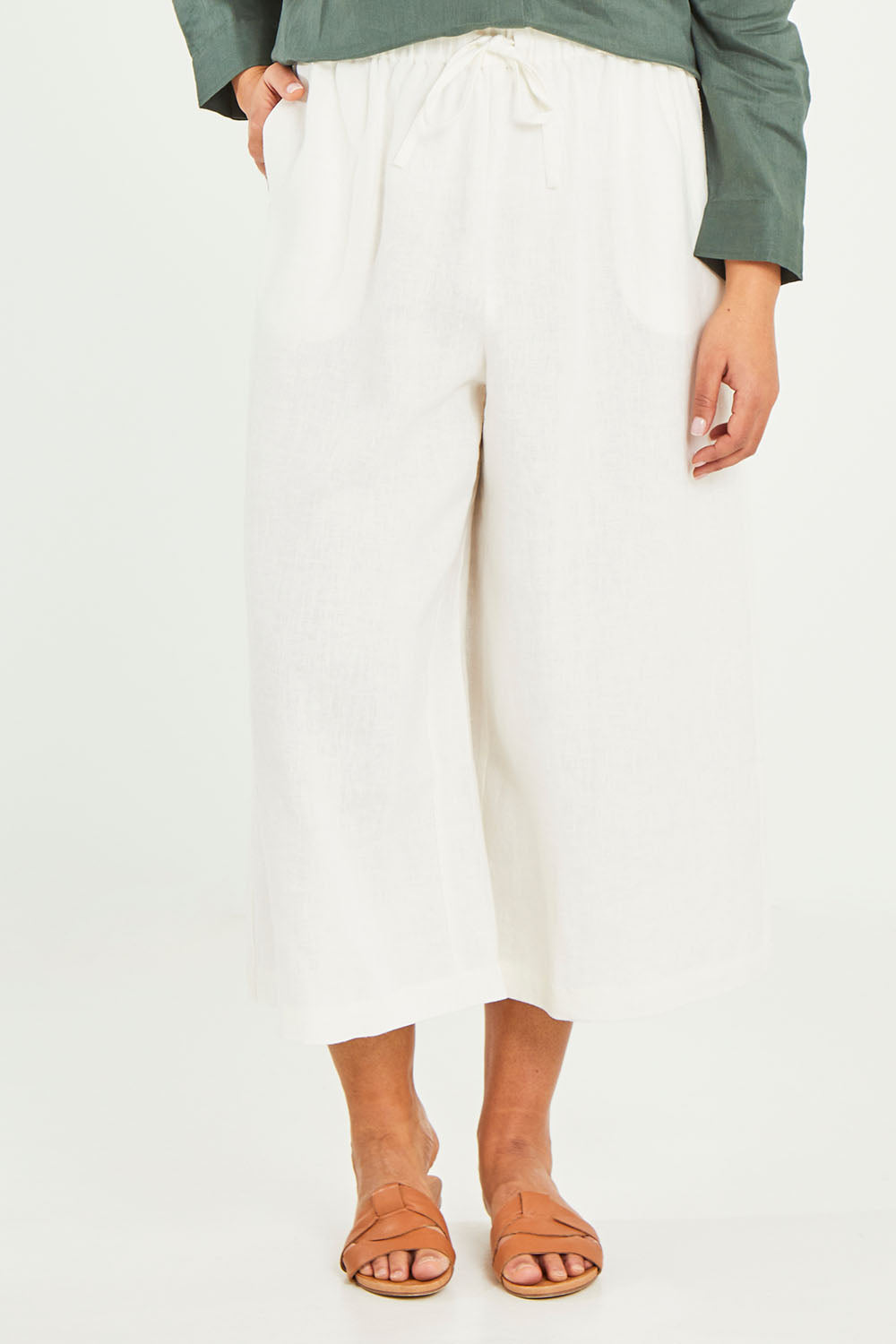 Model Terri-Leigh wearing size 14 of the Linen Drawstring Pants in colour White (White), from the front, cropped image