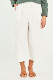 Model Terri-Leigh wearing size 14 of the Linen Drawstring Pants in colour White (White), from the front, cropped image