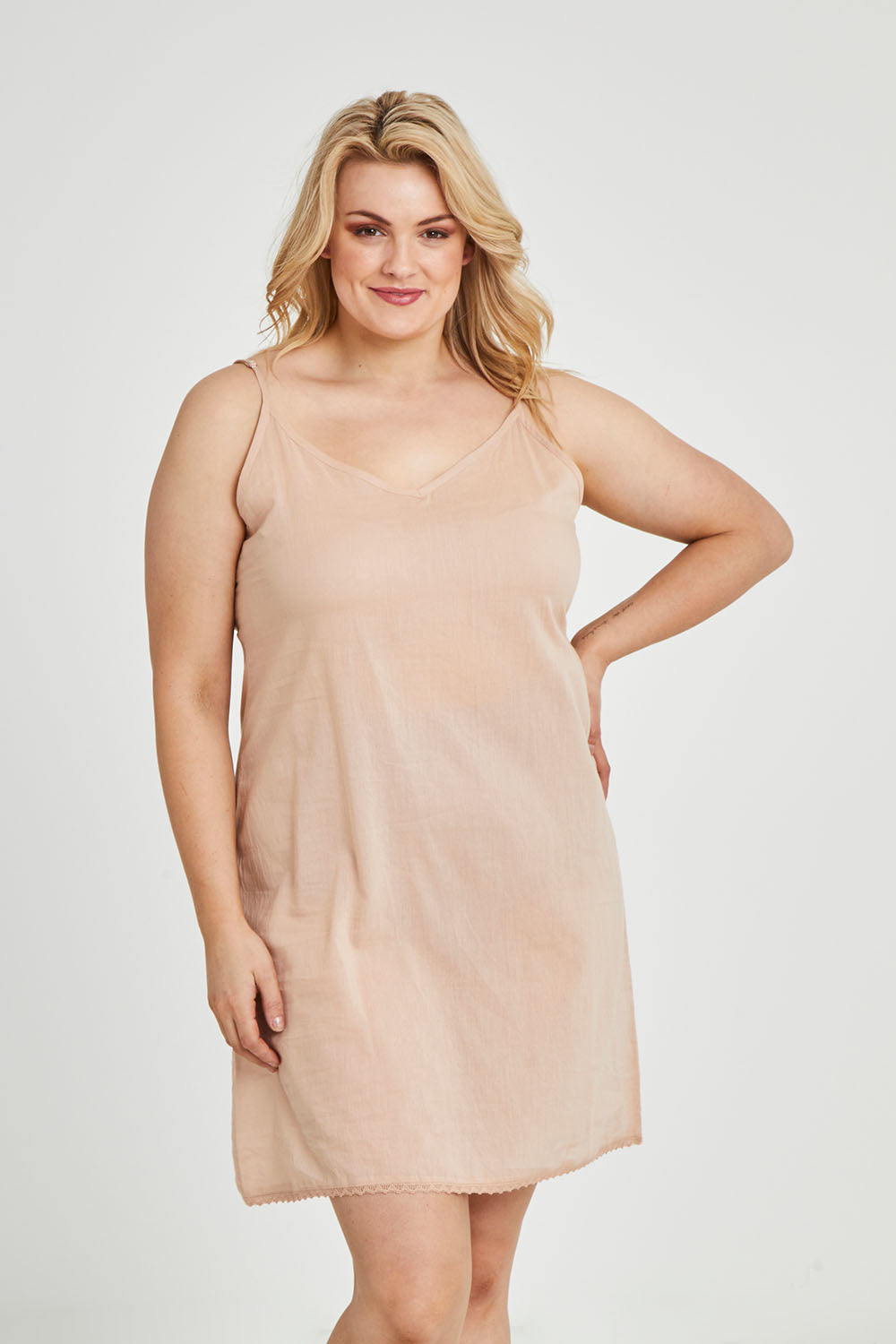Model Keeara wearing size 16 of the Cotton Slip in colour Sand, from the front, cropped image
