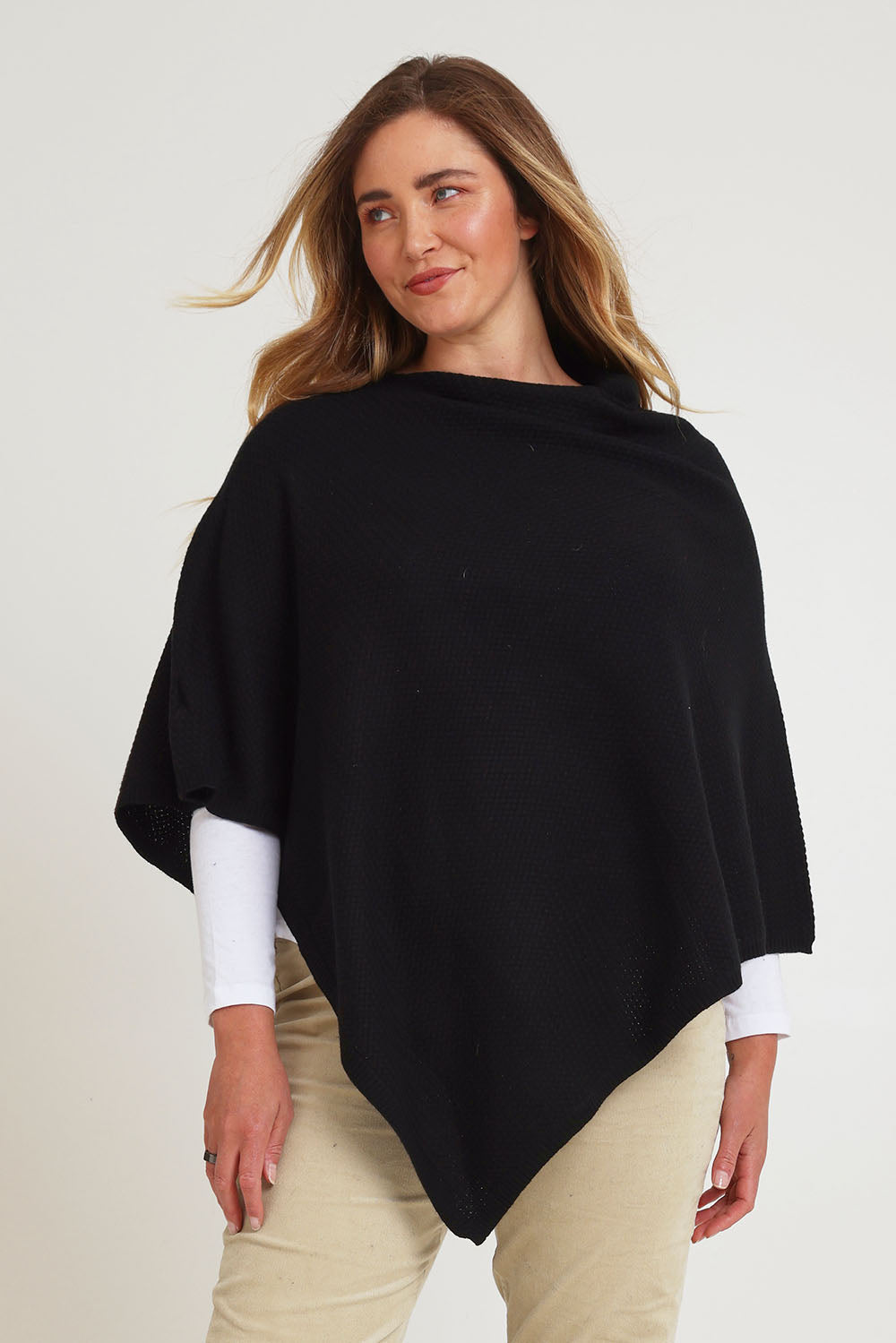 Model Chanel wearing size XL of the Cotton Cashmere Wool Poncho in colour Black (Black), from the front, cropped image