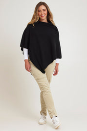 Model Chanel wearing size XL of the Cotton Cashmere Wool Poncho in colour Black (Black), from the front, showing the whole outfit