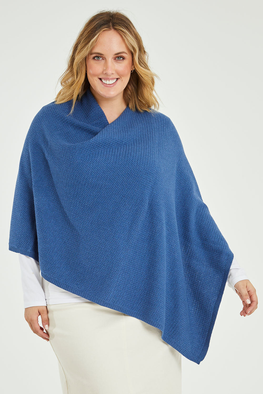 Model Jess wearing size L of the Cotton Cashmere Wool Poncho in colour Blue (Blue), from the front, cropped image