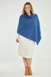 Model Jess wearing size L of the Cotton Cashmere Wool Poncho in colour Blue (Blue), from the front, showing the whole outfit