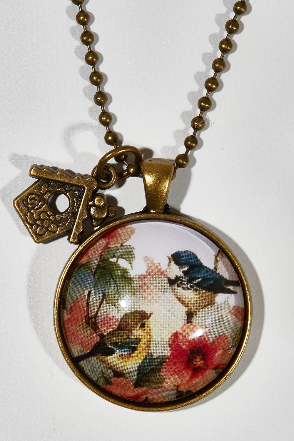 A model wearing the Vintage Bird Pendant w Birdhouse Charm in colour PinkMulti (Pink), from the front, showing the whole outfit