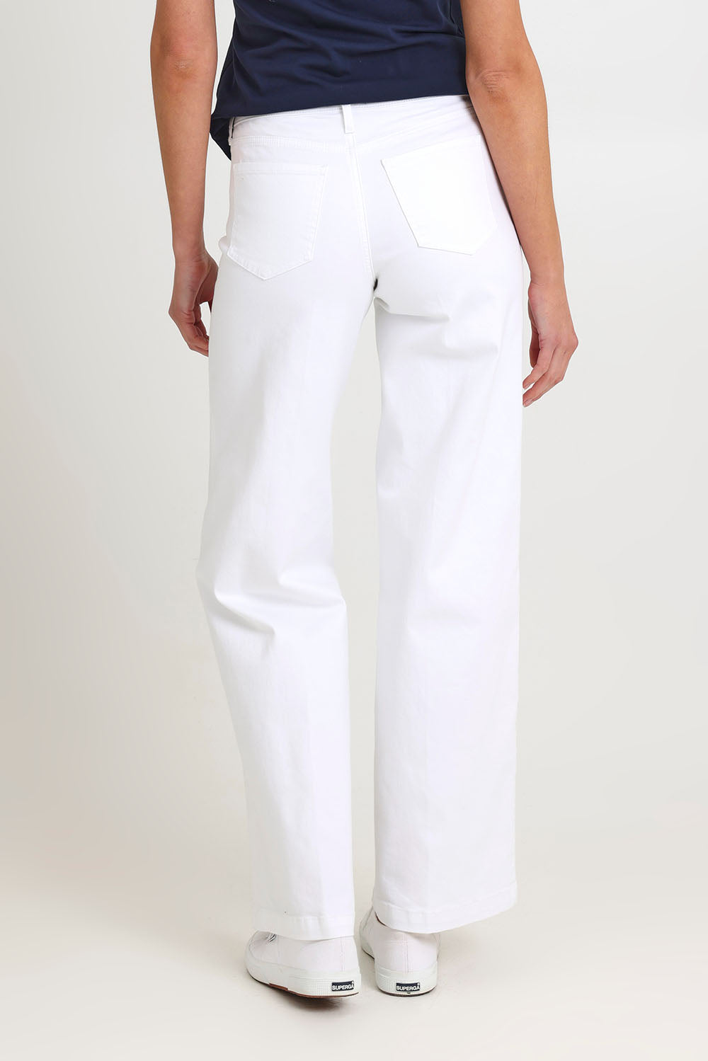 Model Madeline wearing the Teresa Wide Leg Jeans in colour Opticwhite (White), from the back
