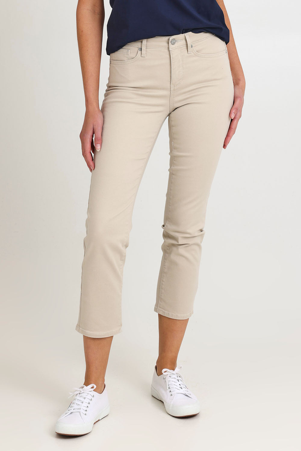 Model Madeline wearing the Sheri Slim Ankle Jean in colour Feather, from the front, cropped image
