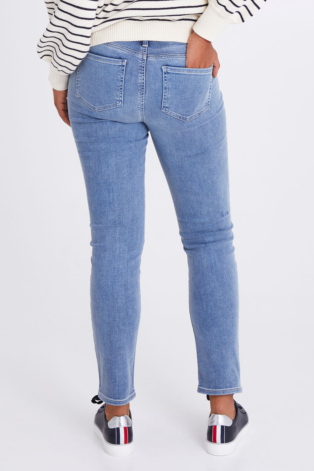 Model Olivia wearing the Sheri Slim Jean in colour Haley (Blue), from the back