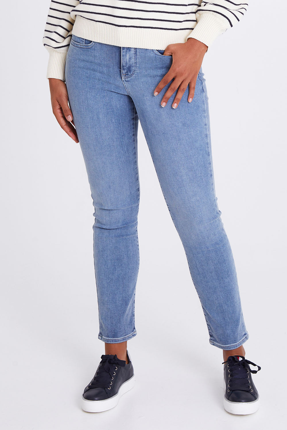 Model Olivia wearing the Sheri Slim Jean in colour Haley (Blue), from the front, cropped image