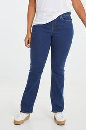 Model Noli wearing the Barbara Bootcut Jean in colour Quinn (Blue), from the front, cropped image