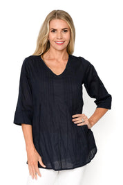A model wearing the Evie 3/4 Sleeve Pleated Cotton Top in colour Navy (Blue), from the front, cropped image