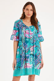 Model Madeline wearing size 10 of the Hannah Short Sleeve Boho Dress in colour Print1 (Blue), from the front, cropped image