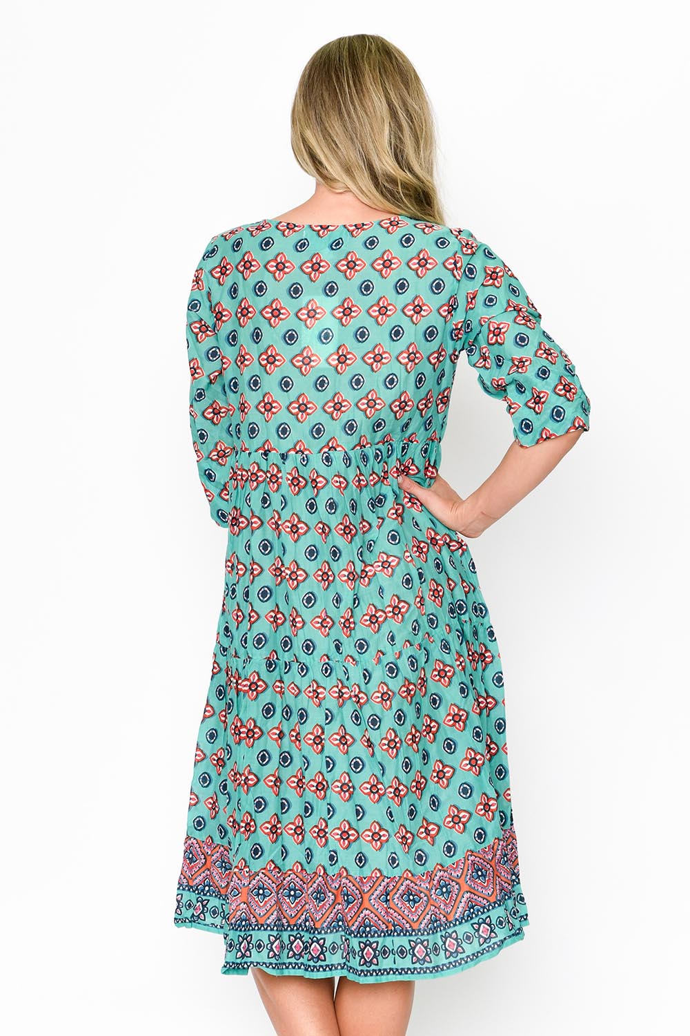 A model wearing the Rebecca Cotton Tie Neck Dress in colour Diamond1 (Blue), from the back