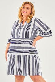 Model Caitlin wearing size 18 of the Maya Button V Neck Layer Dress in colour Navy (Blue), from the front, cropped image