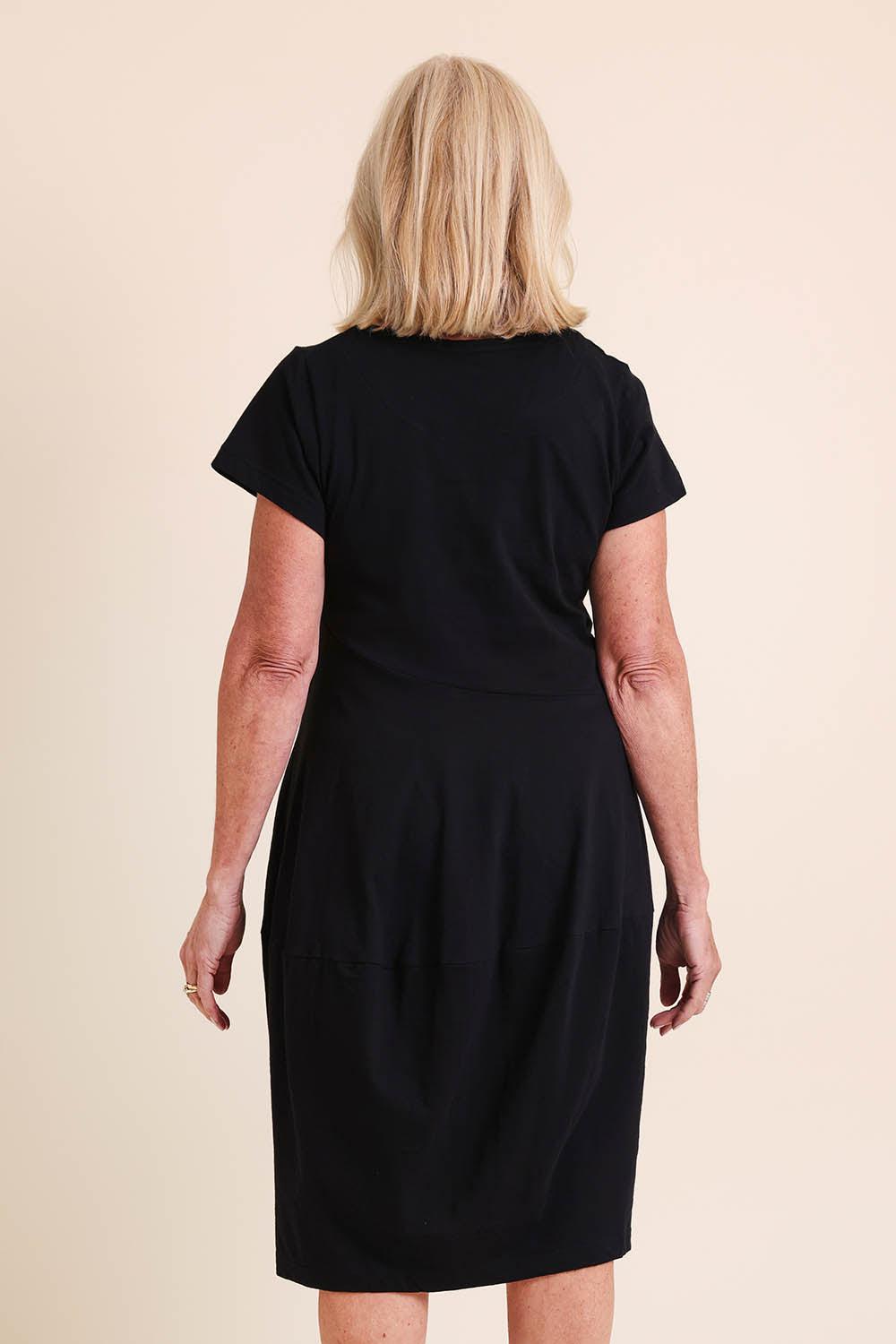 Model Sandys wearing size 10 of the Essentials Bubble Cotton Knit Dress - Black in colour Black, from the back