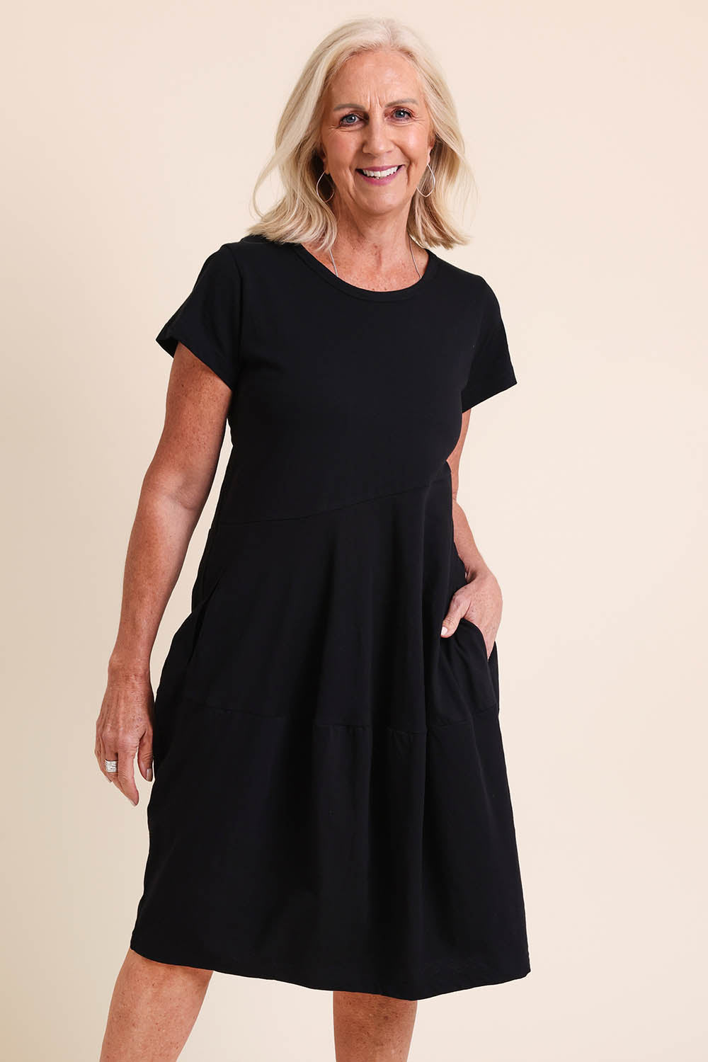 Model Sandys wearing size 10 of the Essentials Bubble Cotton Knit Dress - Black in colour Black, in a cropped view