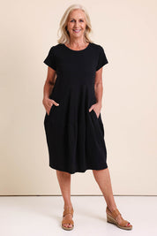 Model Sandys wearing size 10 of the Essentials Bubble Cotton Knit Dress - Black in colour Black, from the front