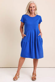 Model Sandys wearing size 10 of the Essentials Bubble Cotton Knit Dress - Blue in colour Blue, from the front