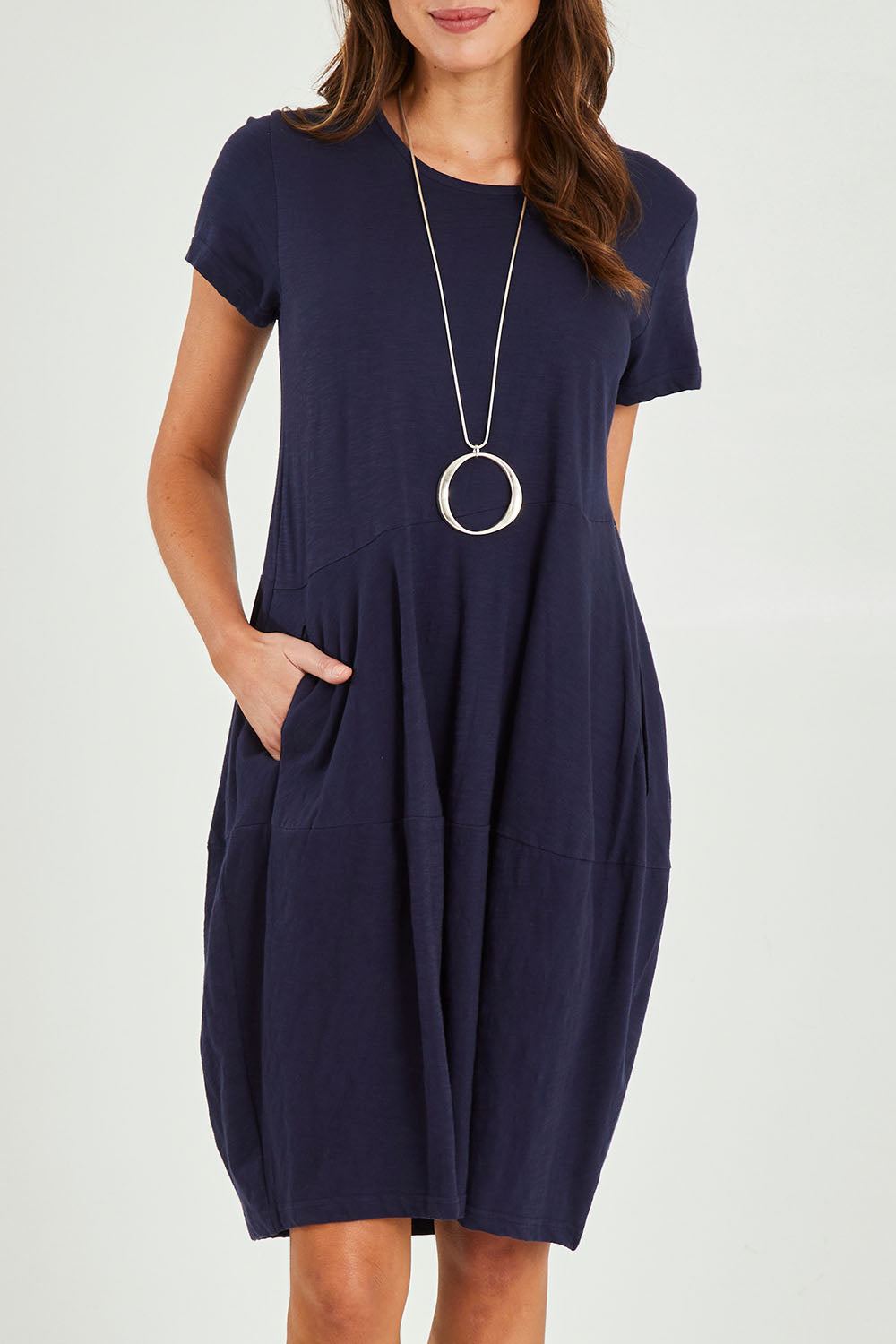 Model Madeline wearing size 10 of the Essentials Organic Cotton Bubble Dress in colour Navy (Blue), from the front, cropped image
