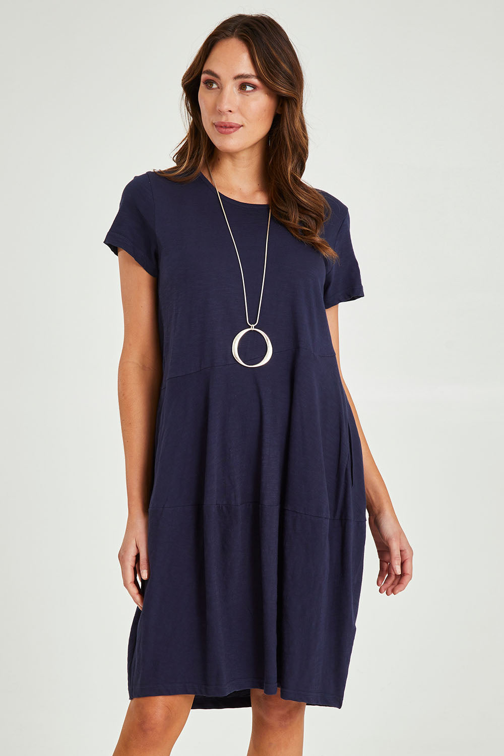 Model Madeline wearing size 10 of the Essentials Organic Cotton Bubble Dress in colour Navy (Blue), from the front, cropped image