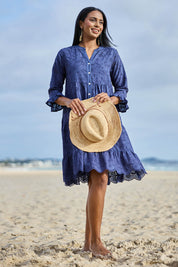 Model Eshan wearing size 10 of the Essentials Broderie Frill Hem and Sleeves Dress - Navy in colour Navy, from the front