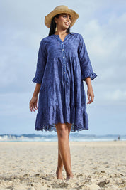 Model Eshan wearing size 10 of the Essentials Broderie Frill Hem and Sleeves Dress - Navy in colour Navy, from the front
