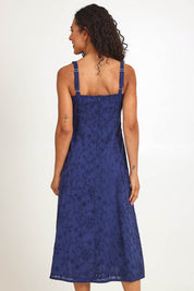 Model Pamelar wearing size 10 of the Essentials Broderie Strappy Cotton Dress - Navy in colour Navy, from the back