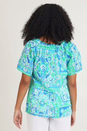 Model Ziara wearing size 10 of the Short Sleeve Cotton Top in colour Aqua (Blue), from the back
