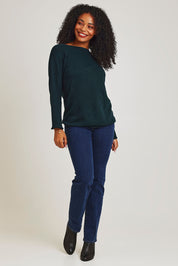 Model Ziara wearing size 10 of the Essentials Organic Cotton Boat Ls Neck Top in colour Pine (Green), from the front, showing the whole outfit