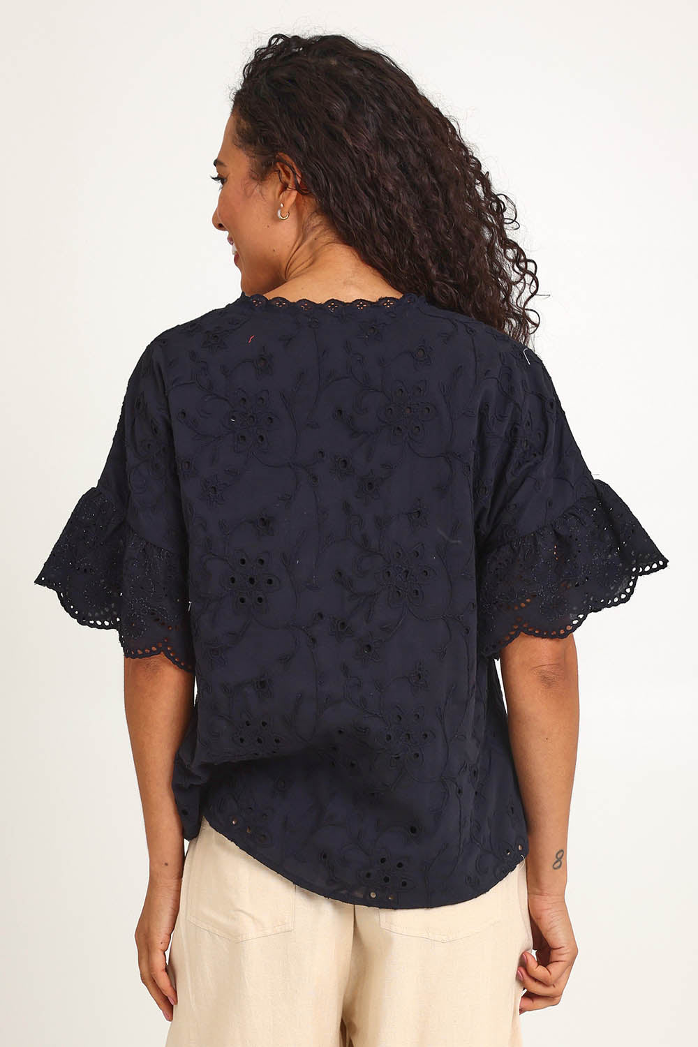 Model Pamelar wearing size 10 of the Essentials Broderie Frill Sleeve Cotton Top - Black in colour Black, from the back