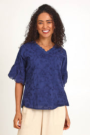 Model Pamelar wearing size 10 of the Essentials Broderie Frill Sleeve Cotton Top - Navy in colour Navy, in a cropped view