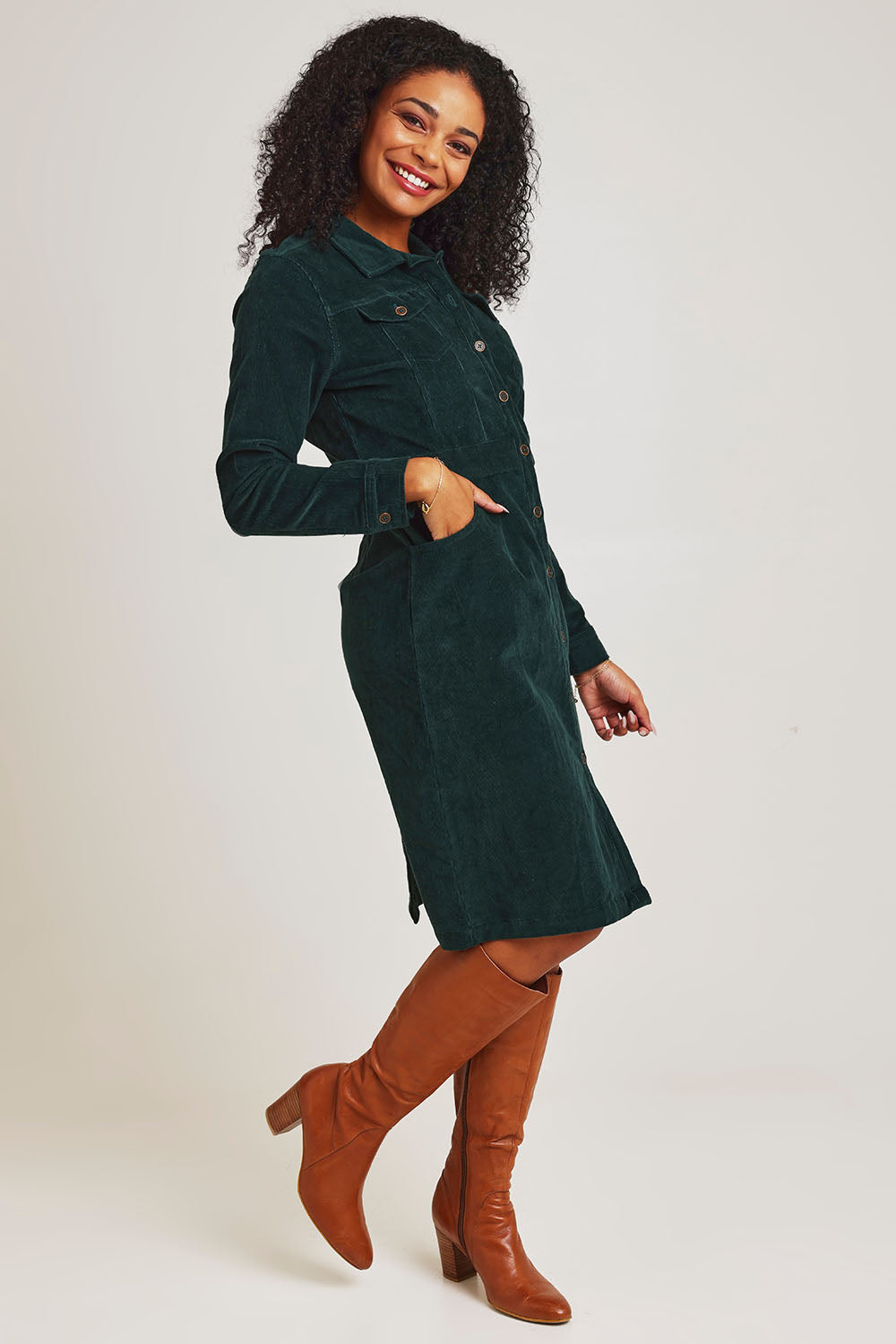 Model Ziara wearing size 10 of the Cotton Corduroy Button Dress in colour Pine (Green), from the front, showing the whole outfit