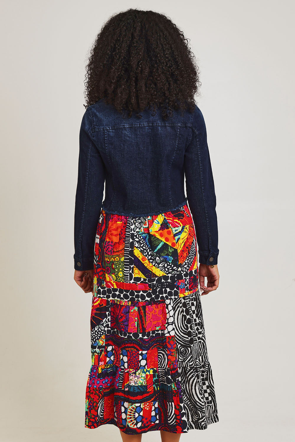 Model Ziara wearing size 10 of the Denim Mix Dress in colour Runaway, from the back
